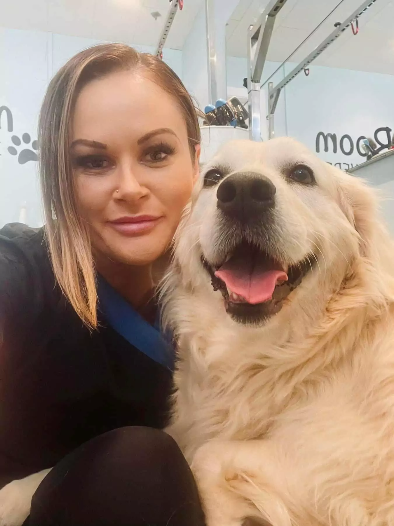 Female learndirect learner smiles for photo with dog