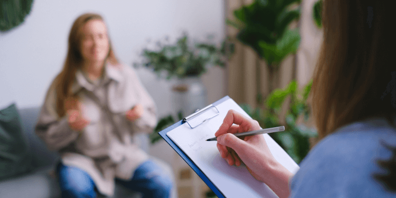 Counselling psychologist providing counselling to a lady 